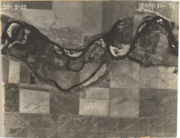 A 1937 aerial survey photo of Fresno County shows agriculture land with a river running through it.