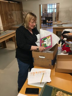 Jennifer Crow unpacks books for display at the exhibition