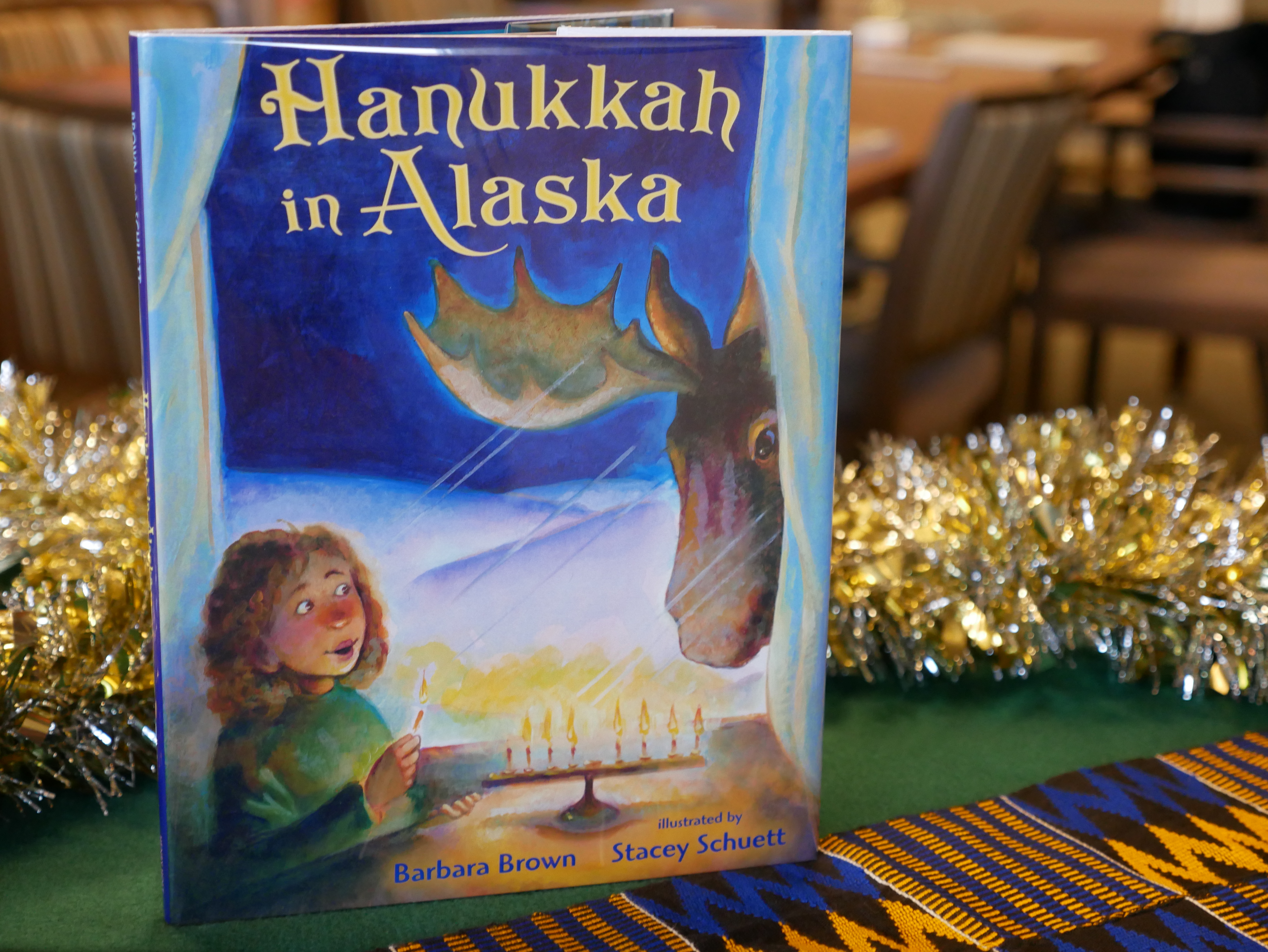 Hanukkah in Alaska by Barbara Brown and Illustrated by Stacey Schuett (Henry Holt and Co, 2013) PZ 7 .B81276 Han Story celebrating Hanukkah and the Aurora Borealis