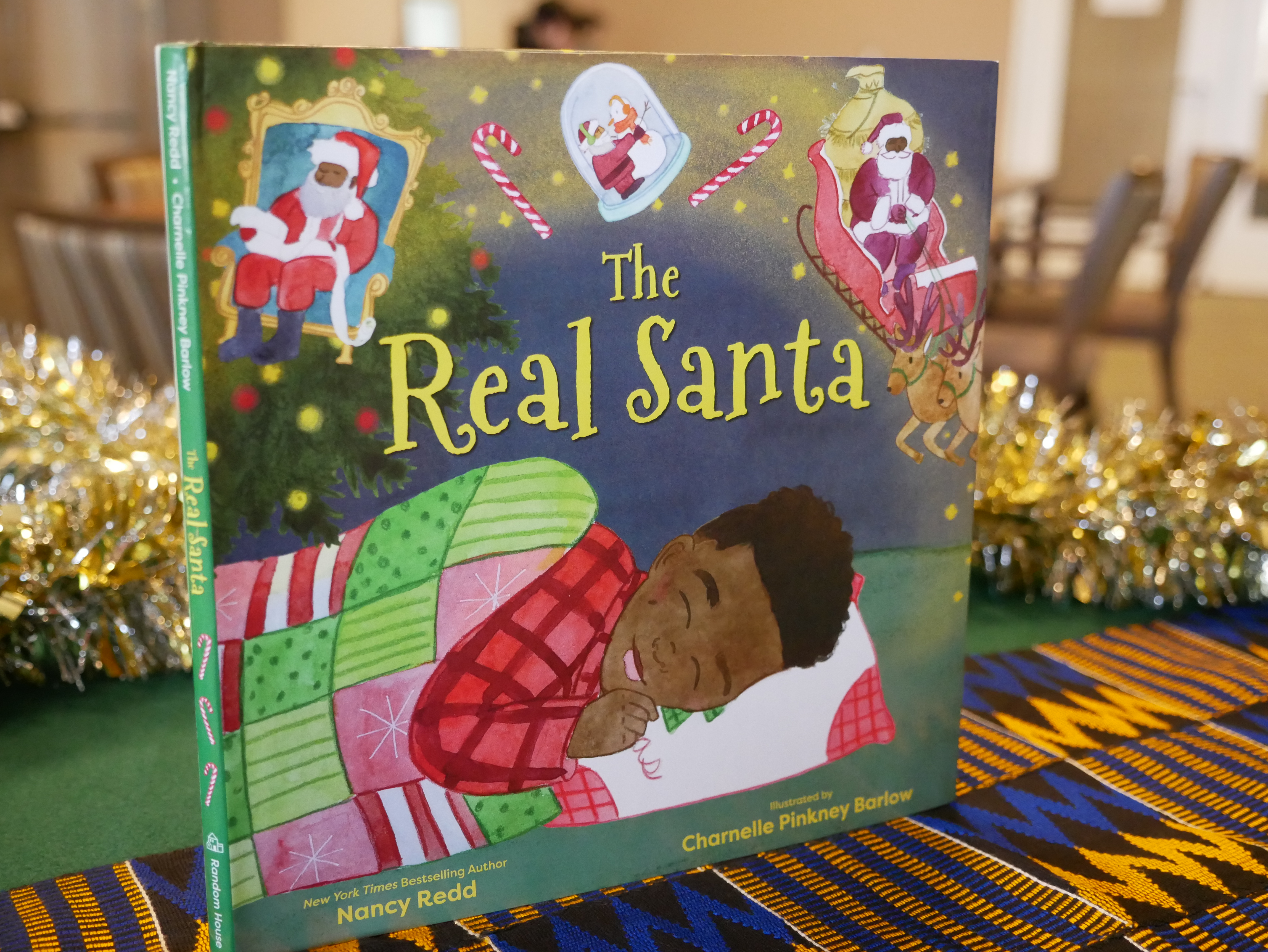 The Real Santa by Nancy Redd and Illustrated by Charnelle Pinkney Barlow (Random House, 2021) Story about a young African American boy who sees himself in Santa and is surrounded by Black santas