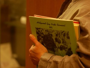 Person holding copies of Gay Pride Carnival programs