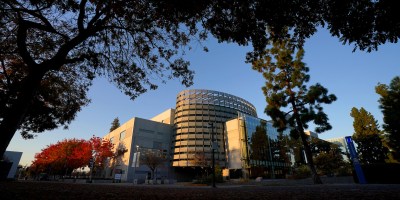 Photo of Fresno State Library surrounded by foliage in the summertime