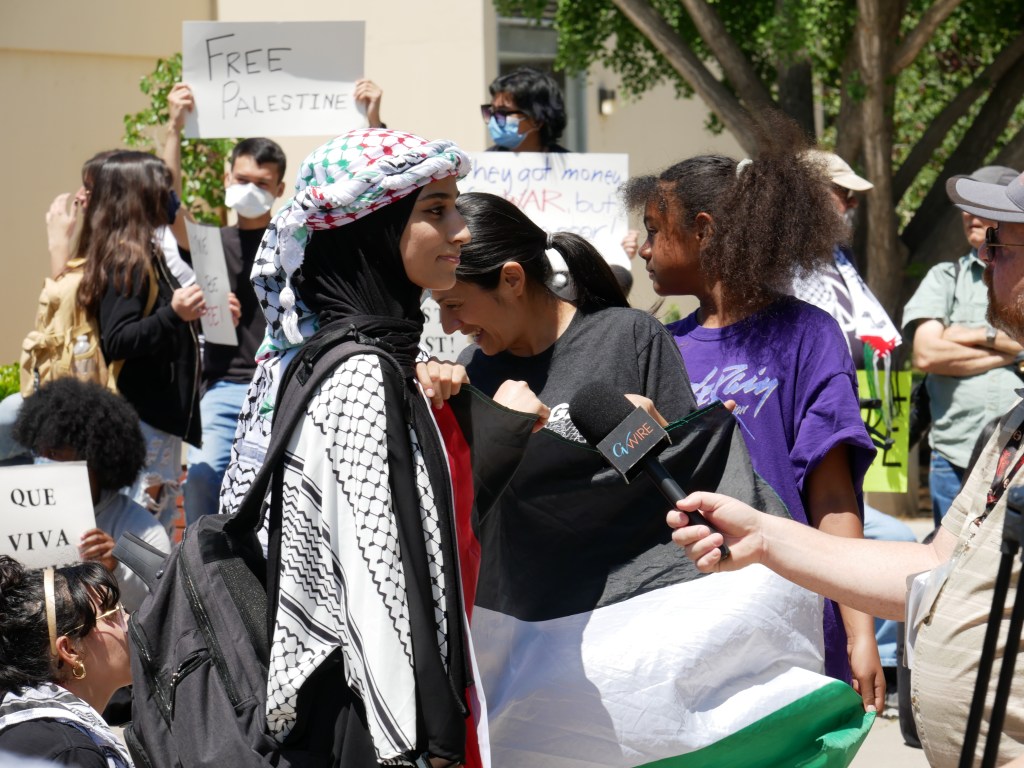 Young woman talking to press. Sit-in for Palestine peaceful demonstration - May 1, 2024 at Fresno State's Free Speech Area. Photo: Tyler Lovejoy