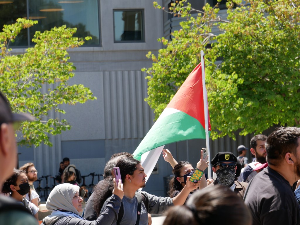 Palestinian flag flies at Sit-in for Palestine peaceful demonstration - May 1, 2024 at Fresno State's Free Speech Area. Photo: Tyler Lovejoy
