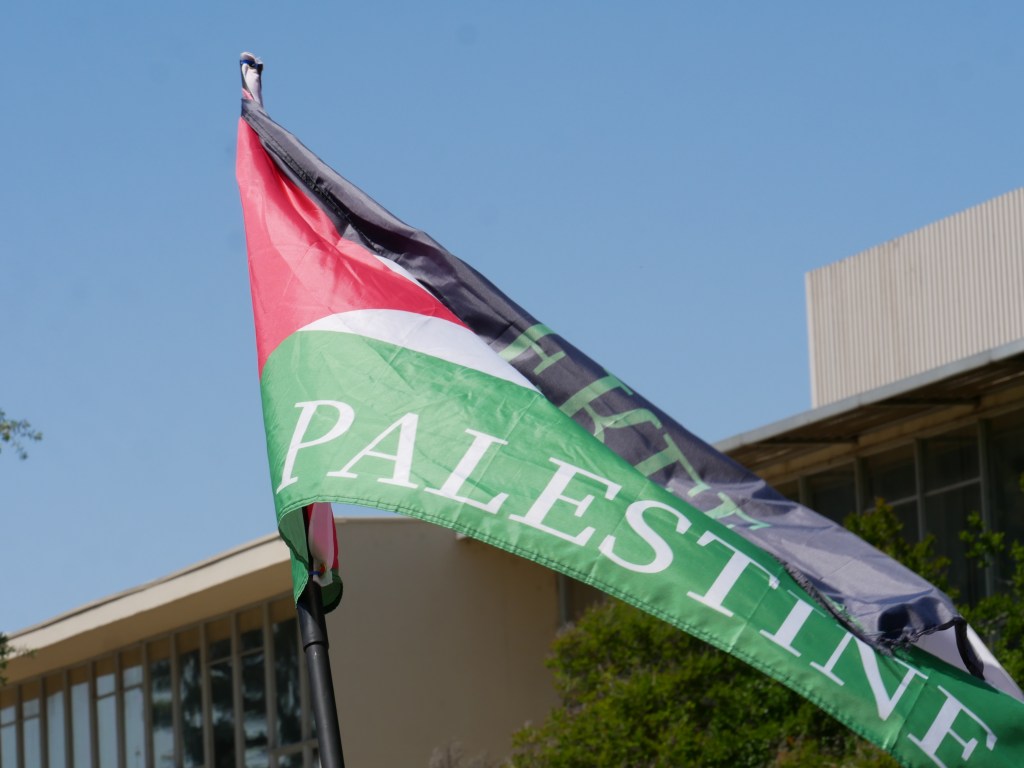 Palestinian flag flies at Sit-in for Palestine peaceful demonstration - May 1, 2024 at Fresno State's Free Speech Area. Photo: Tyler Lovejoy