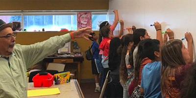 Poet Laureate Juan Felipe Herrera coaches student poets