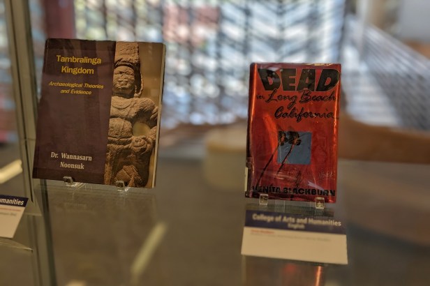 Two books on stands in an exhibit case in the Fresno State Library