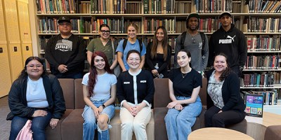 Librarian Shuyi Liu poses with her students in the lower level of the library