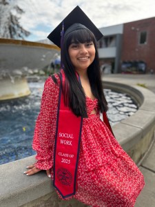 Madison poses in her mortar board abd dress for her graduation photo