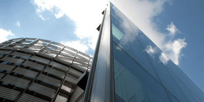 Detail of Fresno State Library Tower against a blue sky with fluffy clouds