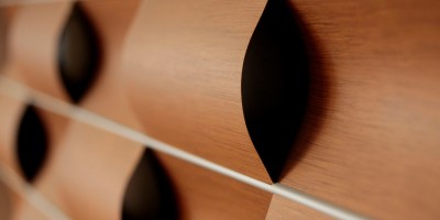 detail of the "wavy wall" installation in the library - wavy wood panels braid in and out of each other.